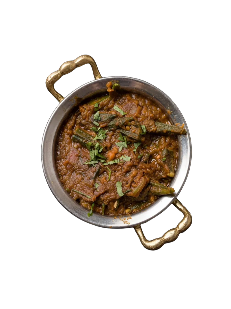 Bhindi masala — okra cooked in tomato-onion masala on a steel plate
