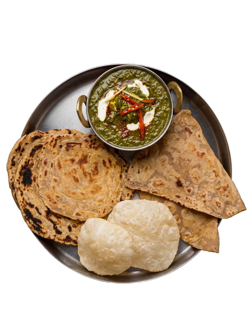 Indian bread basket with assorted tandoor breads on a steel tray