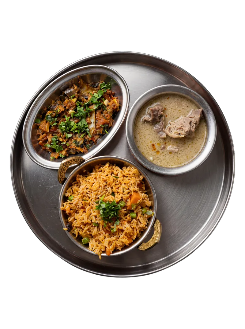 Maharashtrian thali with bhakri, dal, sabzi, and accompaniments on a steel plate