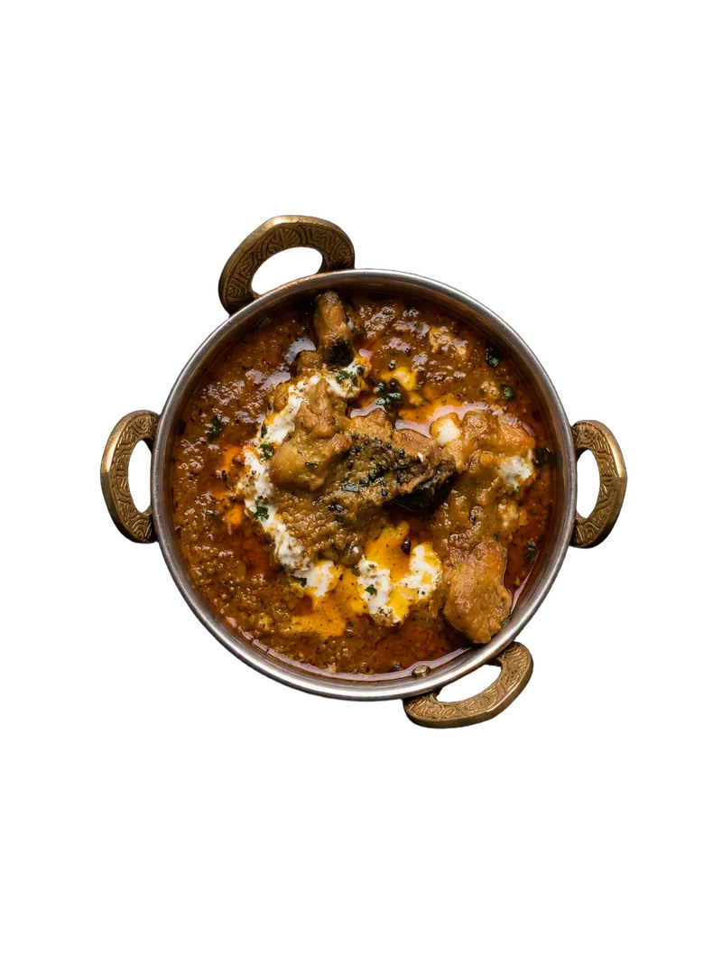 Kadai chicken in a red tomato-based gravy with capsicum and fresh coriander
