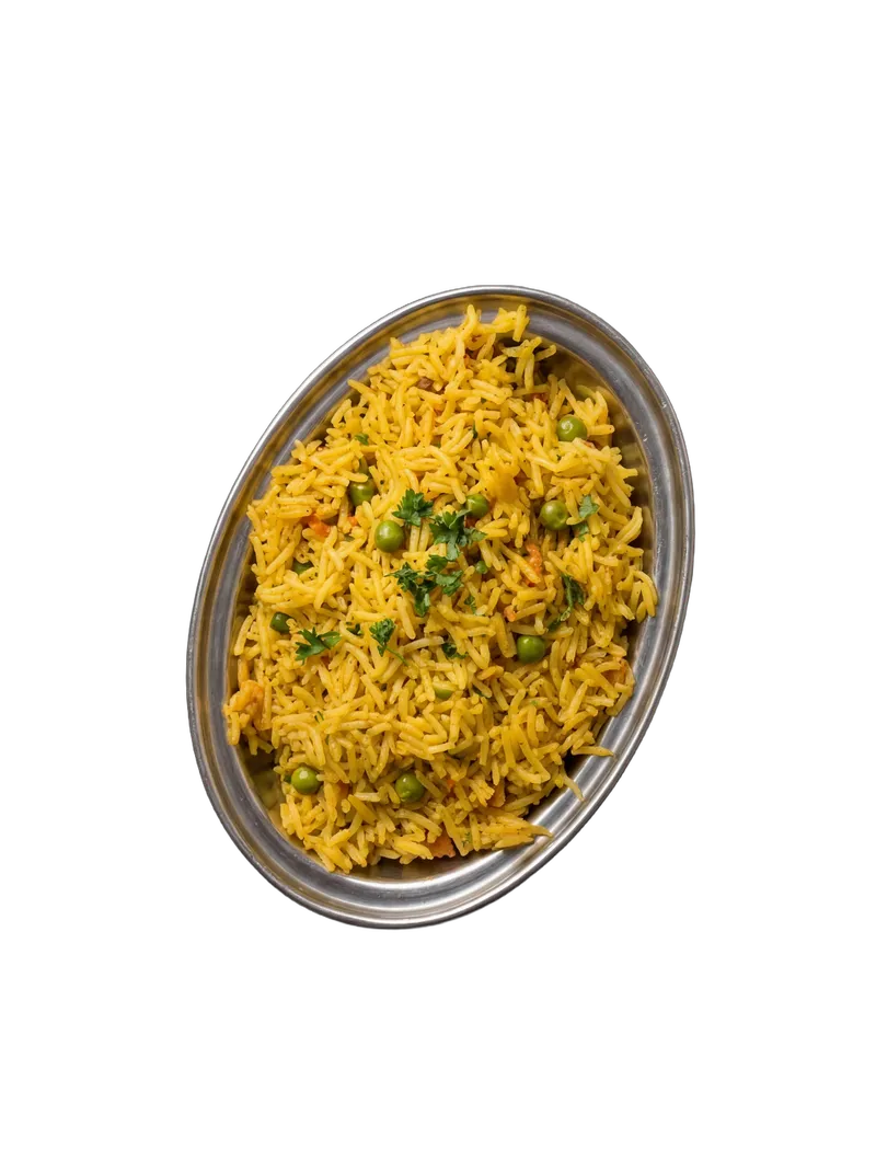 Lemon rice with turmeric, mustard seeds, and curry leaves on a white plate