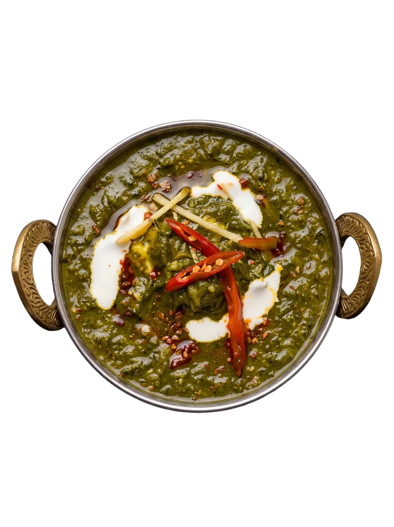 Palak paneer — spinach gravy with cubes of fresh paneer, served with parathas and puri on a steel plate