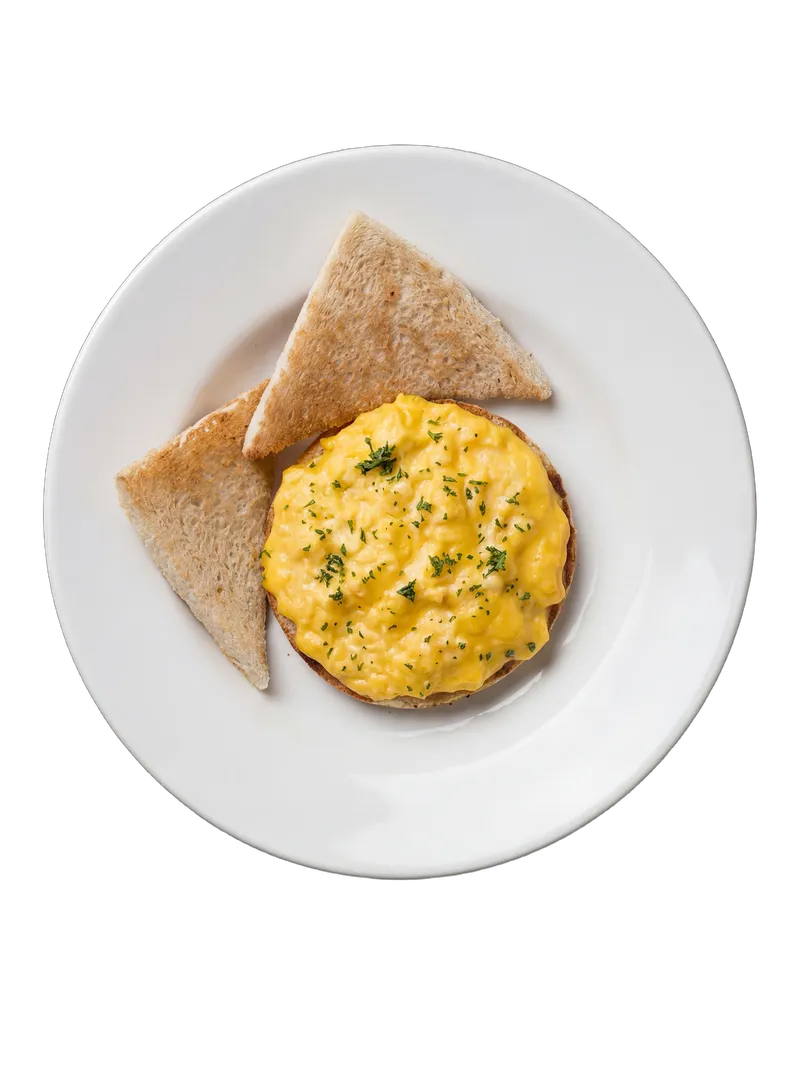Soft scrambled eggs with parsley on toasted brioche triangles