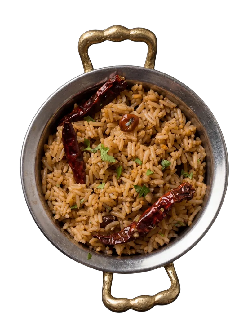 Tamarind rice — puliyodharai with peanuts and curry leaves on a steel plate
