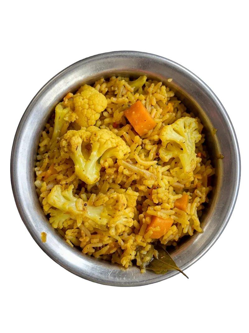Vegetable biryani with saffron rice and mixed vegetables in a steel handi
